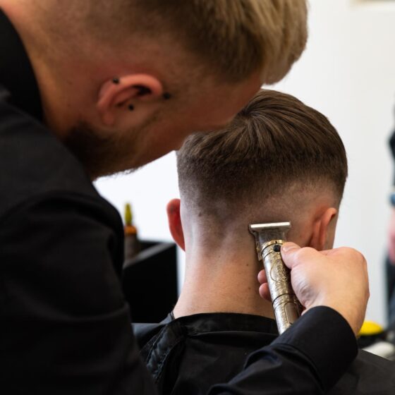 Barber cutting hair and doing a fade